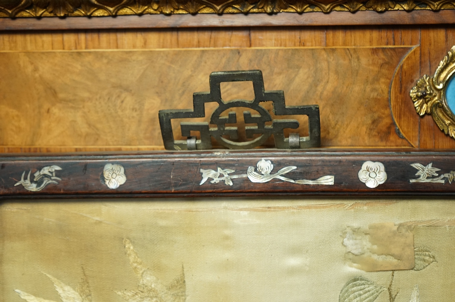 A pair of Chinese embroidered ‘Hundred Bird’ silkwork pictures, c. 1900, in Hongmu and mother-of-pearl inlaid frames, total size 99cm x 32cm. Condition - dark staining and tears to the silk, losses to the mother of pearl